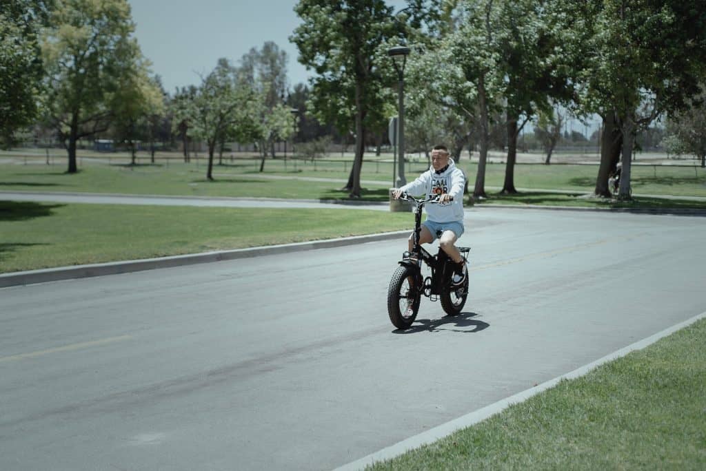 Electric Folding Bike Guide 5 heybike-mars-folding-fat-tire-electric-bike-riding-through-neighborhood